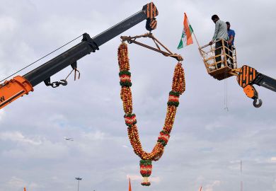 A 20-feet long apple garland is raised with a crane to welcome former Karnataka Minister D.K. Shivakumar, in Bangalore to illustrate No ‘rush to India’ by top-ranked universities, academics say