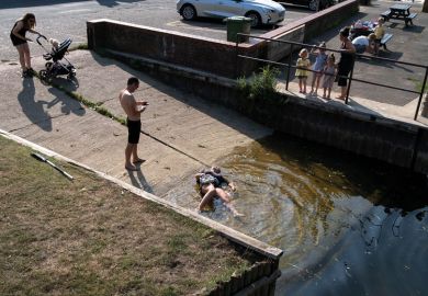 A young woman lies in shallow water after slipping on a boating ramp in Beccles Quay as a metaphor for progress on gender parity in research ‘set back a year’ by Covid
