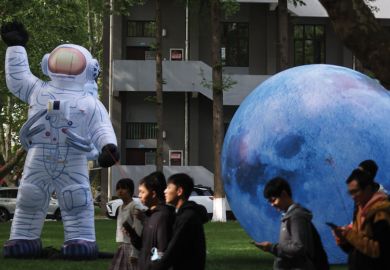 Inflatable models of astronaut and the Moon are on display to illustrate China expands Double First Class universities list