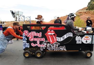 Man pushing a car with a passenger and driver inside.  Man pushes person in car race_as a metaphor for UK universities becoming increasingly reliant on agents for the recruitment of European Union students.
