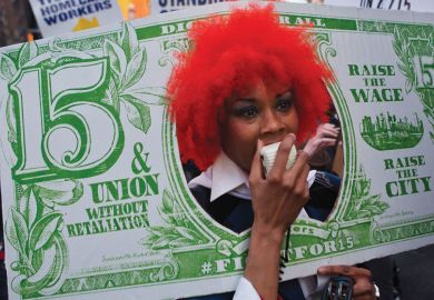 Person with red wig dressed as a fake banknote as a metaphor for US colleges face tougher scrutiny on graduate employment