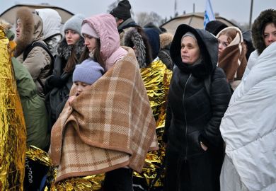 Refugees wrapped in blankets stand in line in the cold as they wait to be transferred to a train station after crossing the Ukrainian border Refugees wrapped in blankets stand in line in the cold as they wait to be transferred to a train station after crossing the Ukrainian border to illustrate Five universities join forces to offer ‘wrap-around’ support to refugees