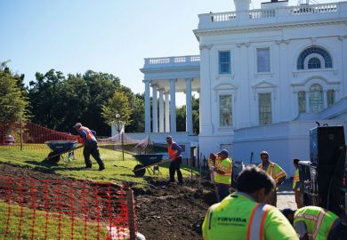 Workers are seen  outside of the Brady Briefing Room as the White House undergoes renovations  to illustrate Biden sets stricter limits on colleges making a profit