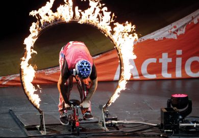 Person behind a circle of fire Person behind a fire circle as a metaphor for new regulations while cutting funding ‘callous’