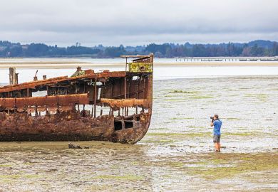 Tourist photographs the Janie Sedan Shipwreck, New Zealand, Oceania, South Island to illustrate New Zealand funding model ‘not fit for purpose’