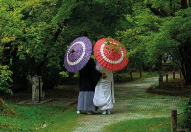 Japanese couple with umbrellas in the botanic garden, Kansai region, Kyoto, Japan Japanese couple with umbrellas in the botanic garden, Kansai region, Kyoto, Japan to illustrate Newly merged Japan university ‘model’ for sector, says president
