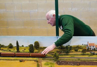 A model train enthusiast works on their railway to illustrate Scholars ‘stumble through’ as British Library tools stay offline