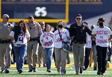  Protestors are escorted off the field by police after preventing the start of the Southern California vs. California NCAA college football game to illustrate Craving for truth in del Valle protests