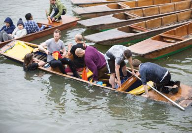Cambridge University students trying to get into a boat on the River Cam in Cambridge as a metaphor for NCH clings to ‘Oxbridge’ dream
