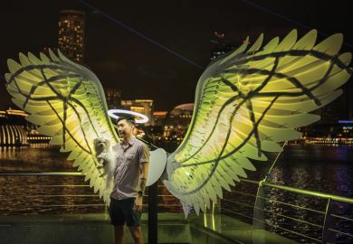 Person being photographed in a light installation in Singapore as the Arts university a milestone for Singapore
