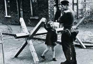 A young girl talking to a British soldier manning a roadblock on a street in Belfast, Northern Ireland during The Troubles, summer 1973 A young girl talking to a British soldier manning a roadblock on a street in Belfast, Northern Ireland during The Troubles, summer 1973