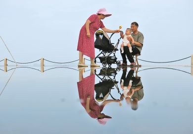 An elderly couple tease their grandson in Yantai, Shandong Province of China to illustrate Ten years to prepare for demographic cliff edge, China warned