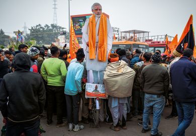 Devotees gather near an effigy of Indian prime minister Narendra Modi at the Ram Mandir Temple Devotees gather near an effigy of Indian prime minister Narendra Modi at the Ram Mandir Temple to illustrate Political attacks on Indian HEIs must end