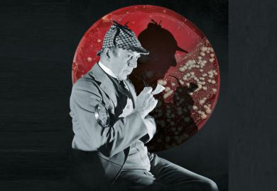 Studio portrait of a man dressed as British detective Sherlock Holmes with a plaid cap, a meerschaum pipe, and a magnifying glass. His silhouette is visible in the background