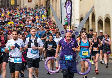 Huge crowd of runners with a charity runner wearing a scissors  fancy dress costume to illustrate ‘£3 billion cut’: inflation analysis reveals loss
