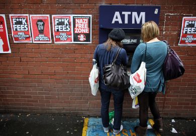 Students arriving for Manchester University's freshers week queue up at a cash machine in Manchester, England. 