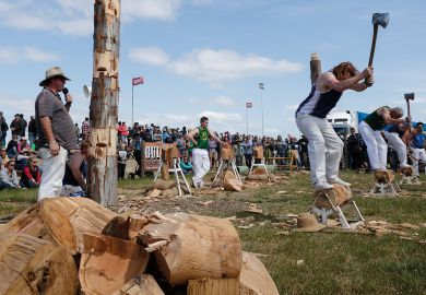  Men compete in a wood chopping competition Deniliquin, Australia to illustrate Immigration risk ratings downgraded at 11 Australian universities