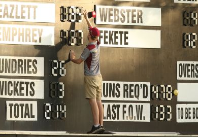 A scorer adjusts the scoreboard in Brisbane, Australia