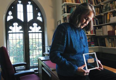 Deceptive text: Karen King with the fragment said to be the Gospel of Jesus’s Wife.The papyrus, now acknowledged as a fabrication