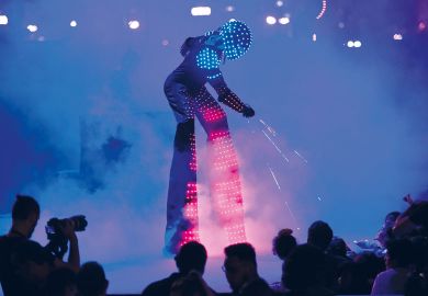   A man in a robot costume performing to illustrate ‘ChatGPT-generated reading list’ sparks AI peer review debate