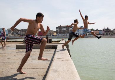 People jump into the North Sea from the Margate Harbour to illustrate Fury at Kent’s plans to cut academics’ time for research
