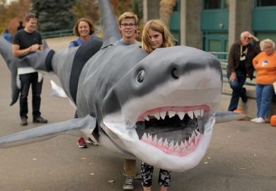 People inside a shark costume People inside a shark costume
