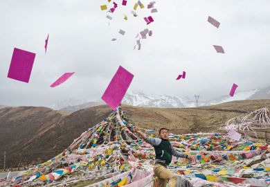 A Tibetan man throws prayers in the air at a high altitude.jpg A Tibetan man throws prayers in the air at a high altitude as a metaphor for leading Chinese universities axe publication condition for PhDs