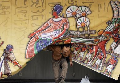 Person appears from under a an Egypt- theme curtain in Beijing to illustrate Asia tipped to follow US lead with open access mandates