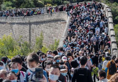 People crowd in a bottleneck as they move slowly on a section of the Great Wall at Badaling People crowd in a bottleneck as they move slowly on a section of the Great Wall at Badaling to illustrate Overseas students struggle to get documents to return to China