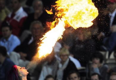 A fire-eater entertains the crowd A fire-eater entertains the crowd to illustrate Australian international education blows hot and cold