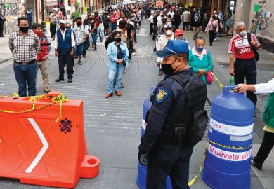Police and city government workers stand at a pedestrian control that limits the access in groups of 20 people to enter downtown Mexico City Police and city government workers stand at a pedestrian control that limits the access in groups of 20 people to enter downtown Mexico City
