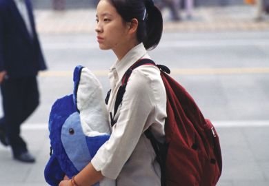 Chinese lady holding toy whale