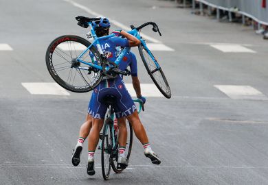 Two people using one bike with person at the back carrying a bike on her shoulder to illustrate US tests new school-university partnerships