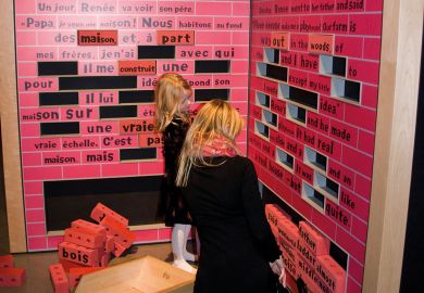 People at an Educational exhibit of Robert Munsch at the McCord Museum Montreal Canada looking at an exhibit of words missing to illustrate McGill warns French-language plan ‘puts its future in question’
