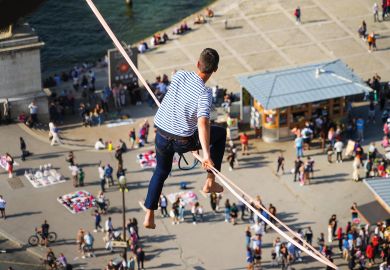 Tightrope walker Nathan Paulin traverses a slackline between the Eiffel Tower and the Trocadero Square to illustrate French universities avoid worst in election but face uncertainty