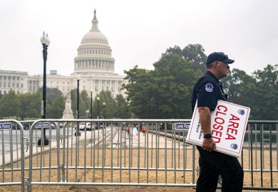 A U.S. Capitol police officer carries "Area Closed" signs in front of the U.S. Capitol  A U.S. Capitol police officer carries "Area Closed" signs in front of the U.S. Capitol  to illustrate Could US education department be shut?