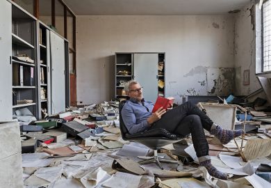 Montage of a person sitting reading in an Abandoned office with many papers on the floor Montage of a person sitting reading in an Abandoned office with many papers on the floor