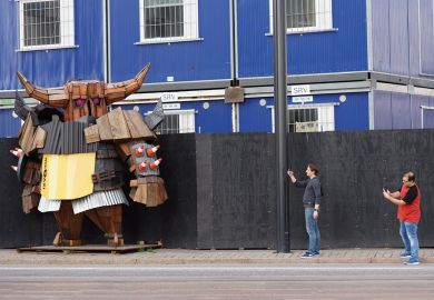 Tourist take photos of a wooden statue of Viking in helmet at the ecological construction site on Jatkasaari island in Helsinki, Finland Tourist take photos of a wooden statue of Viking in helmet at the ecological construction site on Jatkasaari island in Helsinki, Finland to illustrate Will Finland’s spending on  R&D buy it the gift of growth?