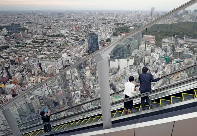 Visitors look out at the view while riding up an escalator at the Shibuya Sky observation deck in Tokyo to illustrate Students protest as Japanese universities mull tuition fee hikes
