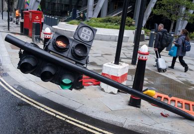 Traffic lights have been knocked over on Leadenhall in the City of London to illustrate International students bear brunt of marking crisis