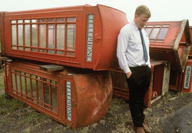 Person with with old phone boxes for sale Person with with old phone boxes for sale
