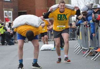 Competitors take part in the World Coal Carrying Championships in Gawthorpe, West Yorkshire to illustrate Staff and students bowed by workloads