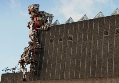 Robot sculptures climbing up the Hayward Gallery, London to illustrate Germany’s largest university buys UK college and degree powers