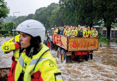 People are being evacuated in a tractor trailer in a flooded street People are being evacuated in a tractor trailer in a flooded street as a metaphor for Europe mulls ‘war games’ to brace for future crises