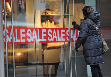 A woman enters a shop displaying a sale sign A woman enters a shop displaying a sale sign for Smaller US colleges try big fee cuts to tempt students back