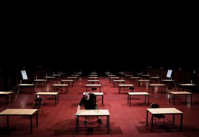 A man disinfects tables in an empty exam room as a metaphor for Is it time to rethink s tudent assessment?