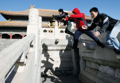 Three people take a  parkour  jump at the Forbidden City in Beijing  Parkour  jump at the Forbidden City in Beijing to illustrate Top Chinese universities trial three-year bachelor’s degrees