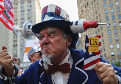 Protestor at "Freedom Rally" to protest the vaccination mandate in New York City to illustrate US campuses retreat from vaccine mandates despite Covid surge