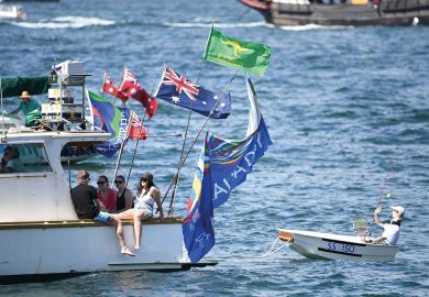 A small boat is being towed on the harbour in Sydney, Australia by a  large boat with people relaxing on board to illustrate the pay disparity data reveal elite clique in Australian universities 