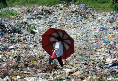 A girl walks through a landfill in Cagayan de Oro, southern Philippines to illustrate Embed climate change content in health degrees, experts say
